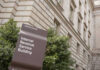 IRS Leak Scandal: Ex-Contractor Convicted! IRS building sign outside government building with greenery
