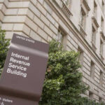 IRS Leak Scandal: Ex-Contractor Convicted! IRS building sign outside government building with greenery