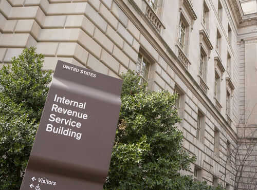 IRS building sign outside government building with greenery