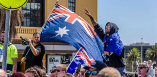 Crowd with Australian flags at an outdoor rally