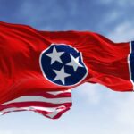 MAGA Boost: Cody Winning Tennessee? Two men in suits on stage at a crowded political rally