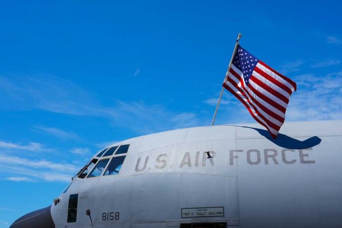 The,Flag,Of,America,Is,Hanging,Over,A,Military,Airplane Close-up of a military aircraft with an American flag