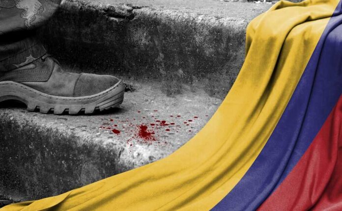 The,Leg,Of,The,Military,Stands,On,The,Step,Next A military boot on concrete steps with blood stains and a Colombian flag draped nearby