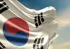 Waving South Korean flag with a blue sky background