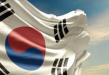 Waving South Korean flag with a blue sky background