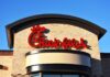 Chick-fil-A restaurant sign against a clear blue sky
