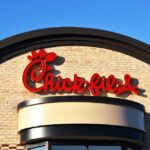 Chick-fil-A restaurant sign against a clear blue sky