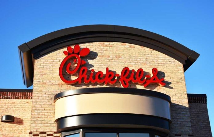 Chick-fil-A restaurant sign against a clear blue sky