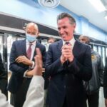 100% TAX SHOCK: Newsom Targets Trump Payouts Group of people engaged in a lively discussion during a public event