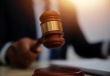 Massive $250M Fraud: Nonprofit Leader’s 41-Year Sentence A gavel being struck on a desk in a courtroom setting