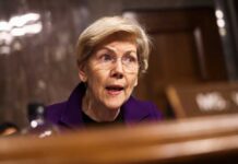 A woman in a purple blazer speaking during a senate hearing