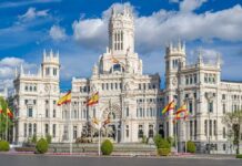 Germany on Edge: Spain’s Migrant Move Raises Alarms A grand historic building with flags in front and a fountain