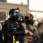 ON-CAM Threat to ICE Agent’s Family — FEDS STRIKE FAST Group of police officers in tactical gear walking in an urban area