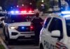 Police officers responding to an incident at night with flashing lights