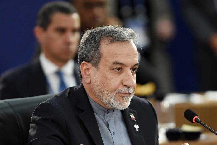 A man in formal attire participating in a political meeting