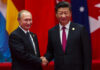 China’s Imperial Welcome: Putin Follows Trump Two international leaders shaking hands at a diplomatic event