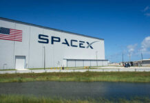 Trillion-Dollar Gamble: SpaceX IPO Sparks Panic SpaceX building with American flag sky background