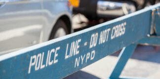 Blue NYPD barricade with Police Line - Do Not Cross.