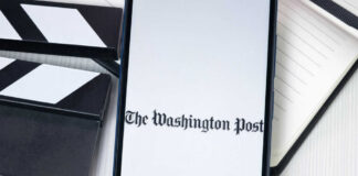 Phone displaying The Washington Post beside clapperboard.