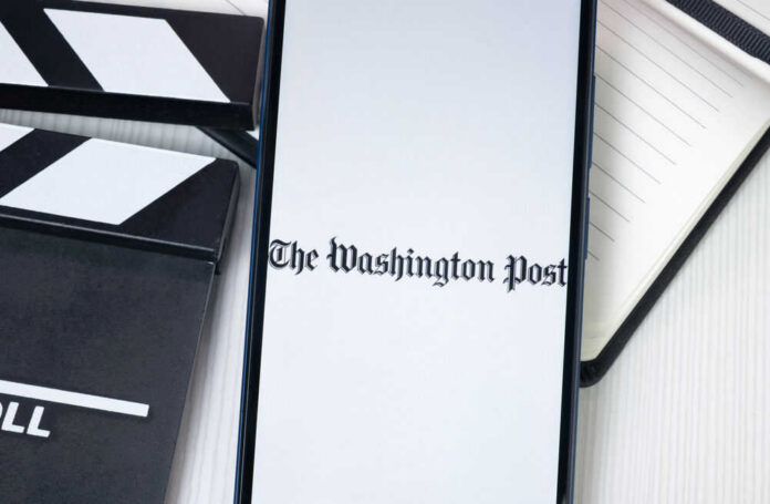 Phone displaying The Washington Post beside clapperboard.