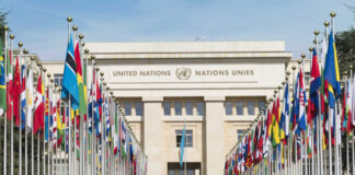 United Nations building with rows of world flags