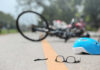 Glasses and helmet on road, bike fallen.