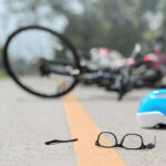 Fly-Tip Trap Shatters Cyclist’s Skull Glasses and helmet on road, bike fallen.