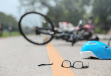Glasses and helmet on road, bike fallen.