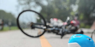 Glasses and helmet on road, bike fallen.