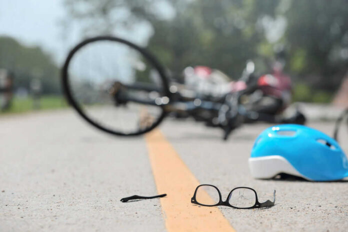 accidents214880782 Glasses and helmet on road, bike fallen.