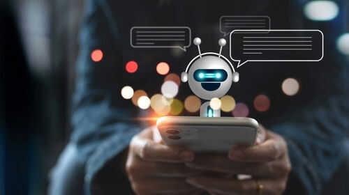 Person using smartphone with chatbot hologram display