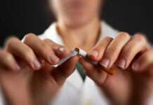 Public Health Caught Playing Politics Hands breaking a cigarette in half