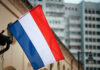 France SIZZLES — Music Fest Booze Axed Netherlands flag waving outside buildings