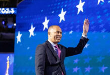CNBC Showdown: Jeffries Cornered On Costs Person waving in front of a starry blue background