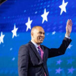 Jeffries Cornered in Fox Interview on Antisemitism Claims Person waving in front of a starry blue background