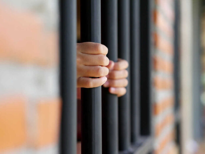 hands-in-jail284924171jpg Hands gripping prison bars