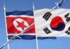 North and South Korean flags with barbed wire.