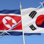 North and South Korean flags with barbed wire.