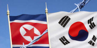 North and South Korean flags with barbed wire.
