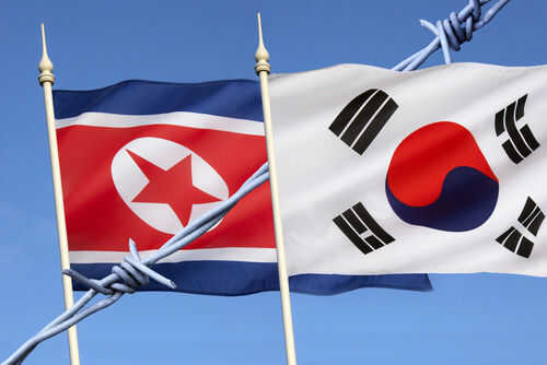 North and South Korean flags with barbed wire.