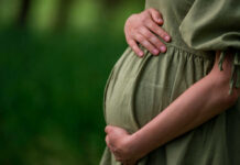 Repeat Offender Outrage — Pregnant Victim Stabbed Pregnant person holding their belly in a green dress