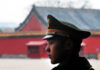 Beijing Tests Red Lines — What Breaks First? A military guard in uniform standing in profile against a historical building