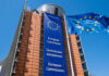 Exterior view of the European Commission building with EU flags