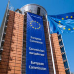 Exterior view of the European Commission building with EU flags