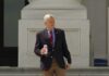 Man sitting at a desk with nameplate Sen Graham