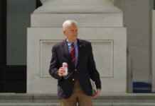 Man sitting at a desk with nameplate Sen Graham