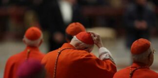 Cardinals in red robes participating in a religious ceremony