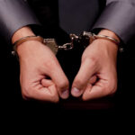 Hands in handcuffs, symbolizing arrest or detention