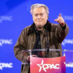 Bannon’s War Room Becomes Right’s Nerve Center Person speaking at CPAC conference blue background