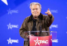 Bannon’s War Room Becomes Right’s Nerve Center Person speaking at CPAC conference blue background